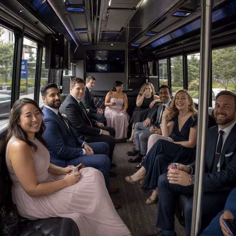 Wedding guests seated inside a Charlotte party bus
