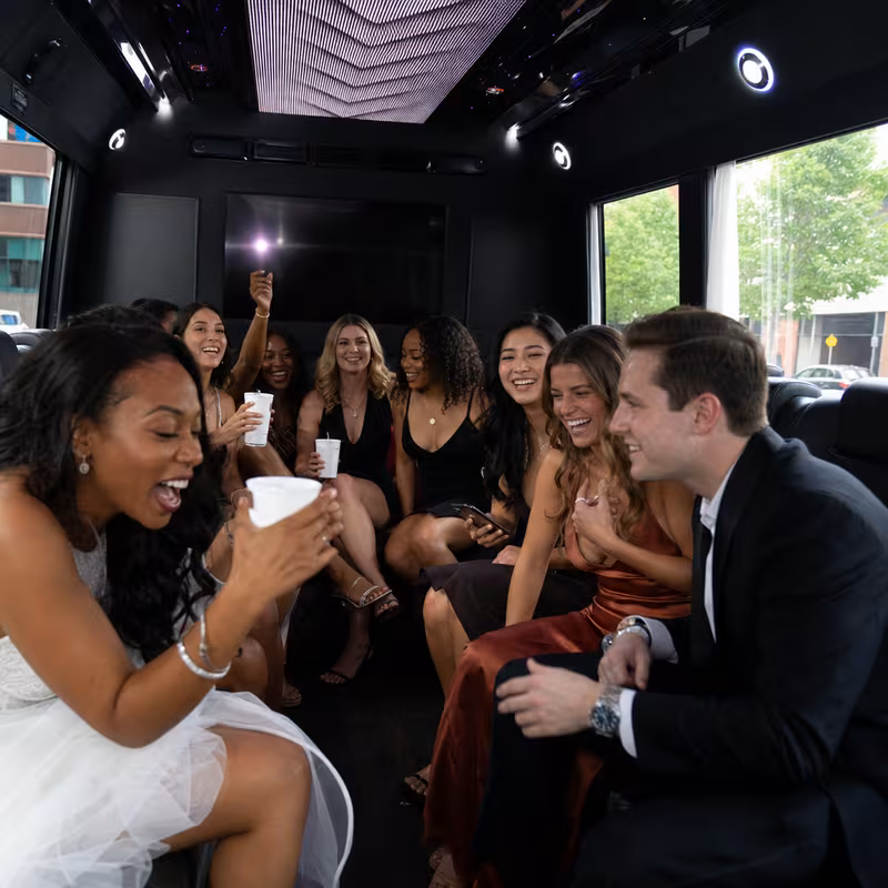 Party bus interior with wraparound leather seating and LED lighting in Charlotte