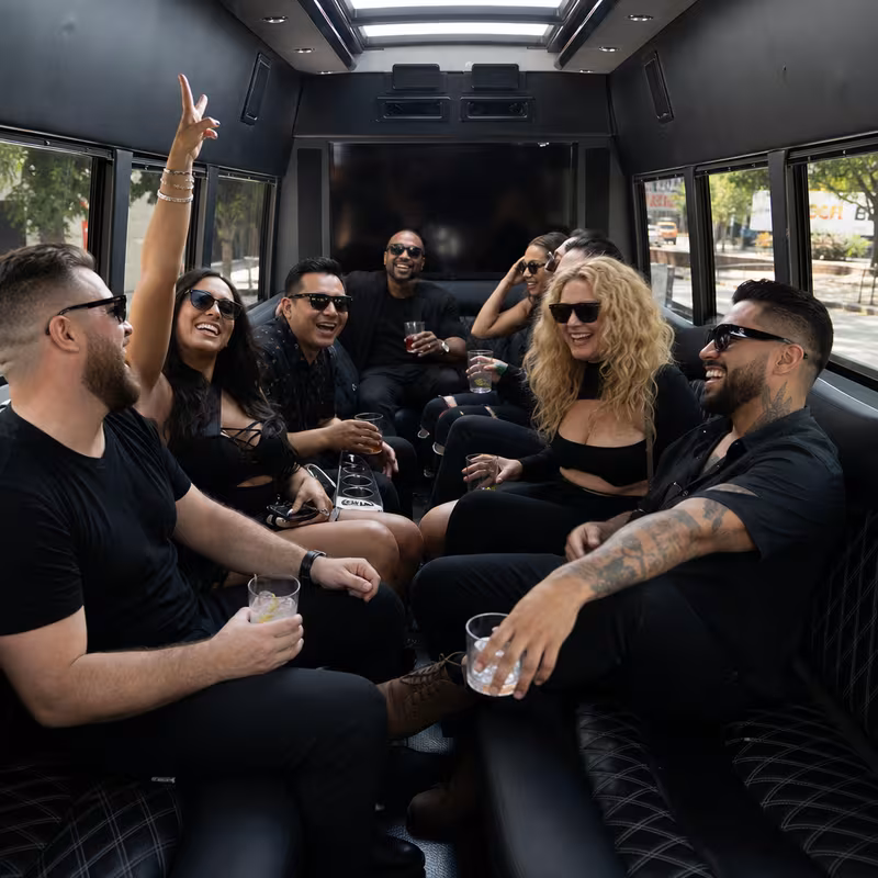 Group boarding a white charter bus for Concert Transportation transportation in Charlotte