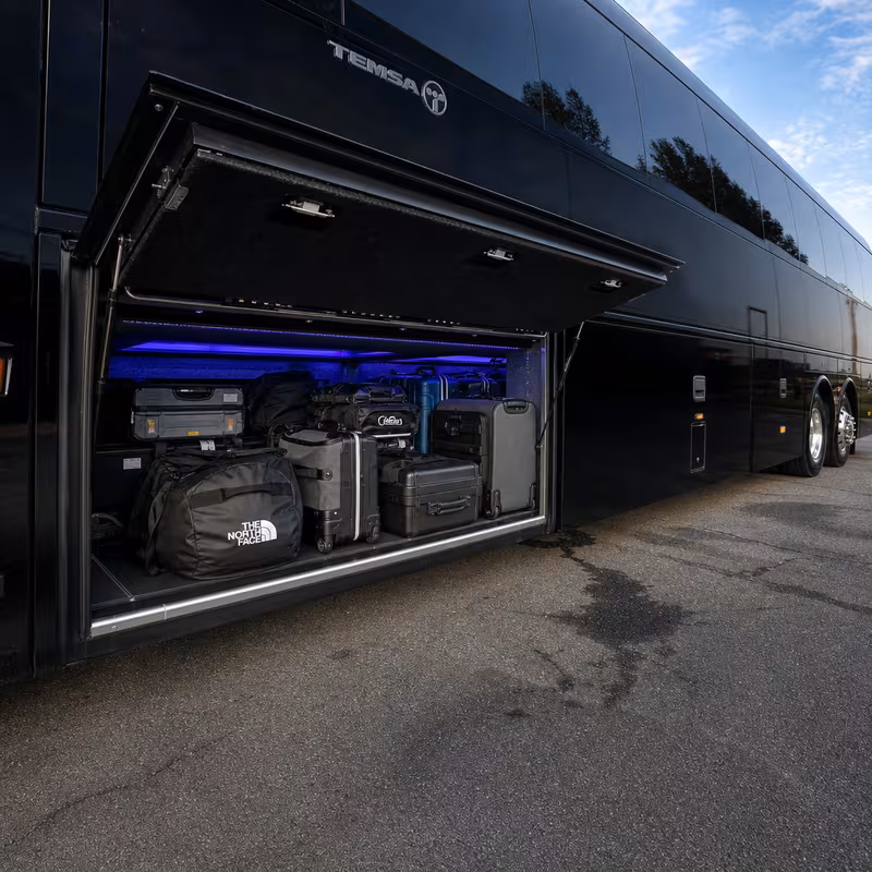 Party bus interior with wraparound leather seating and LED lighting in Charlotte