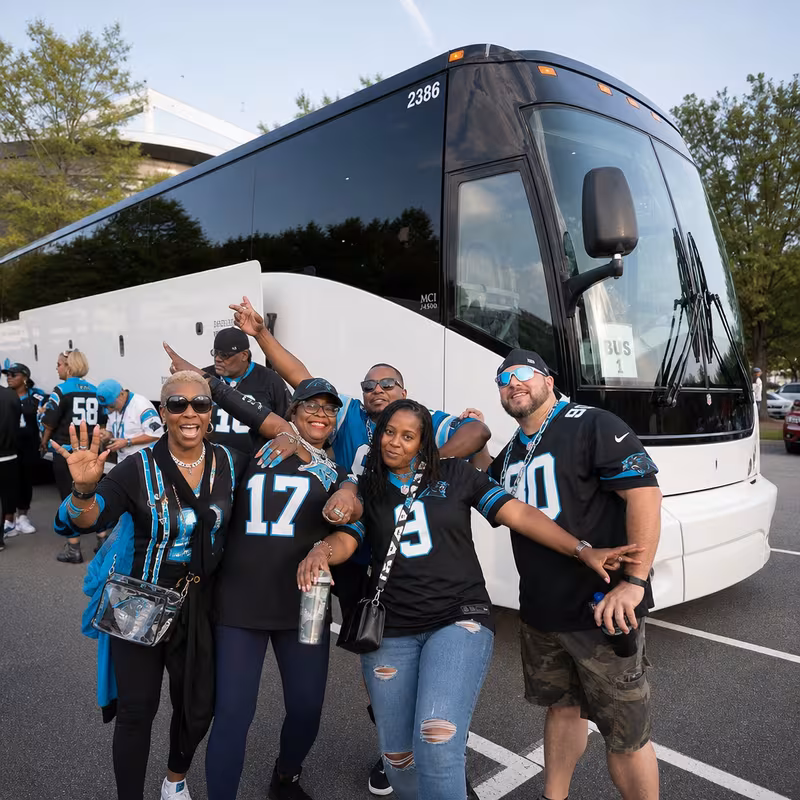 Passengers loading luggage while boarding an Charlotte group shuttle