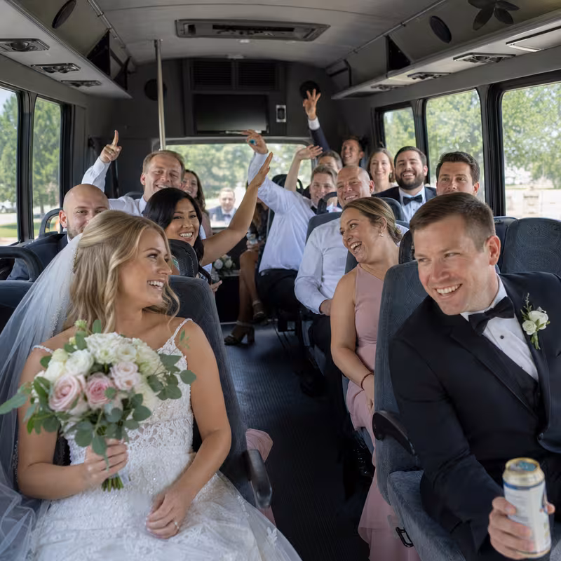 Group boarding a white charter bus for Wedding Transportation transportation in Charlotte