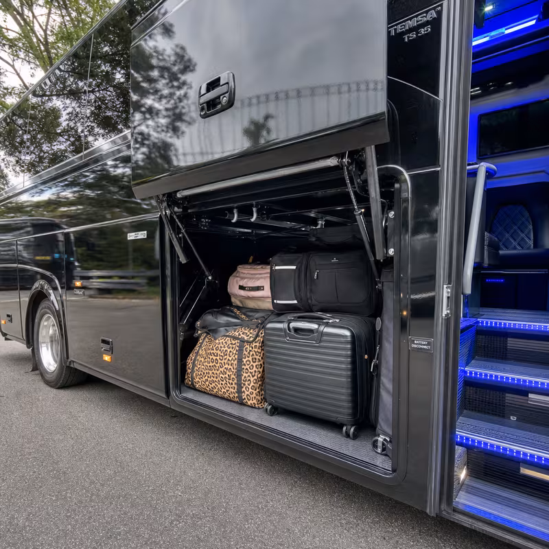 Party bus interior with wraparound leather seating and LED lighting in Charlotte