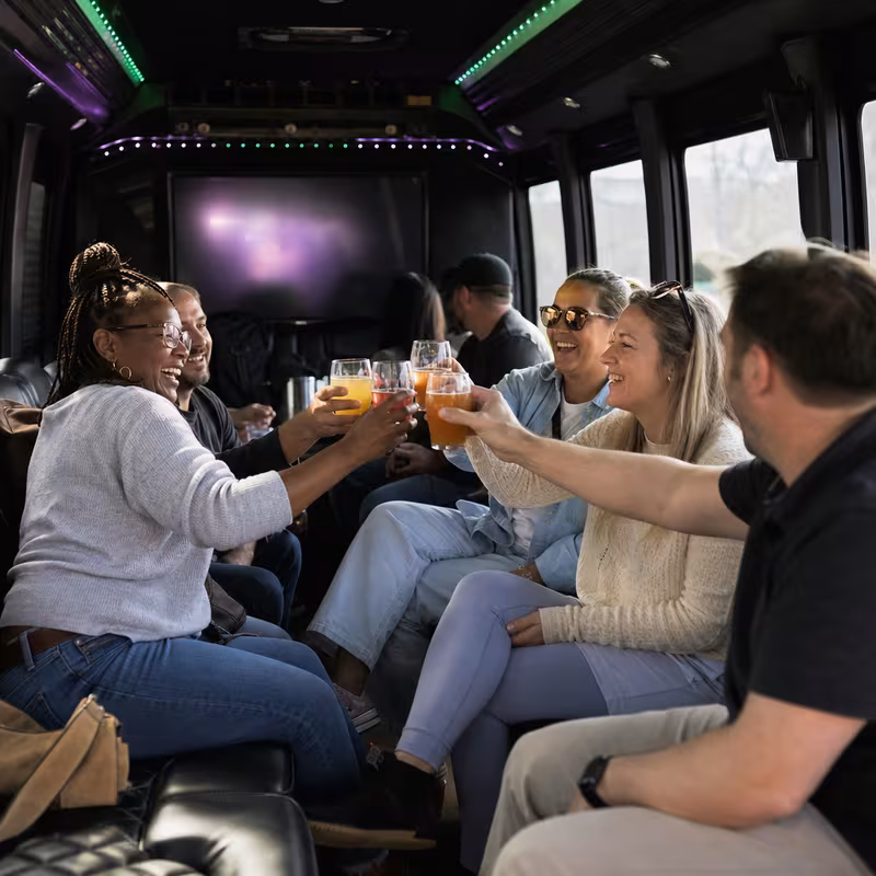Group boarding a white charter bus for Winery & Brewery Tour Transportation transportation in Charlotte