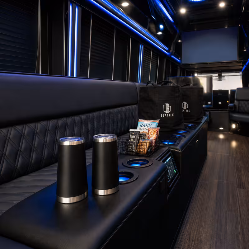 Party bus interior with wraparound leather seating and LED lighting in Charlotte